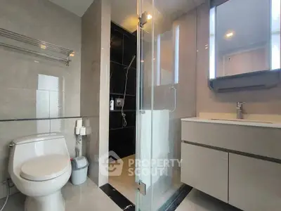 Modern bathroom with sleek fixtures and glass shower enclosure