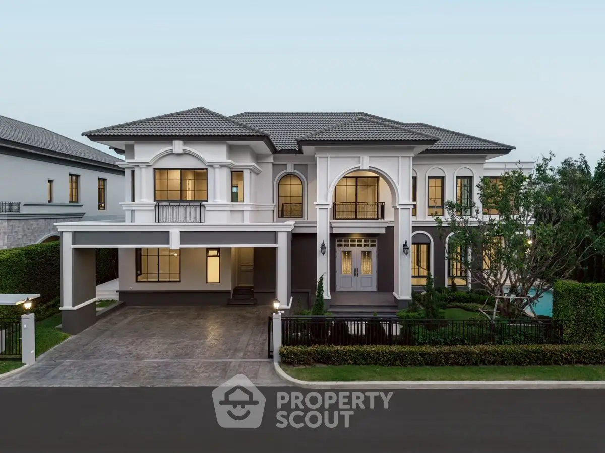 Luxurious two-story house with elegant facade and spacious driveway in upscale neighborhood.