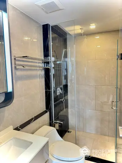 Modern bathroom with glass shower and sleek fixtures