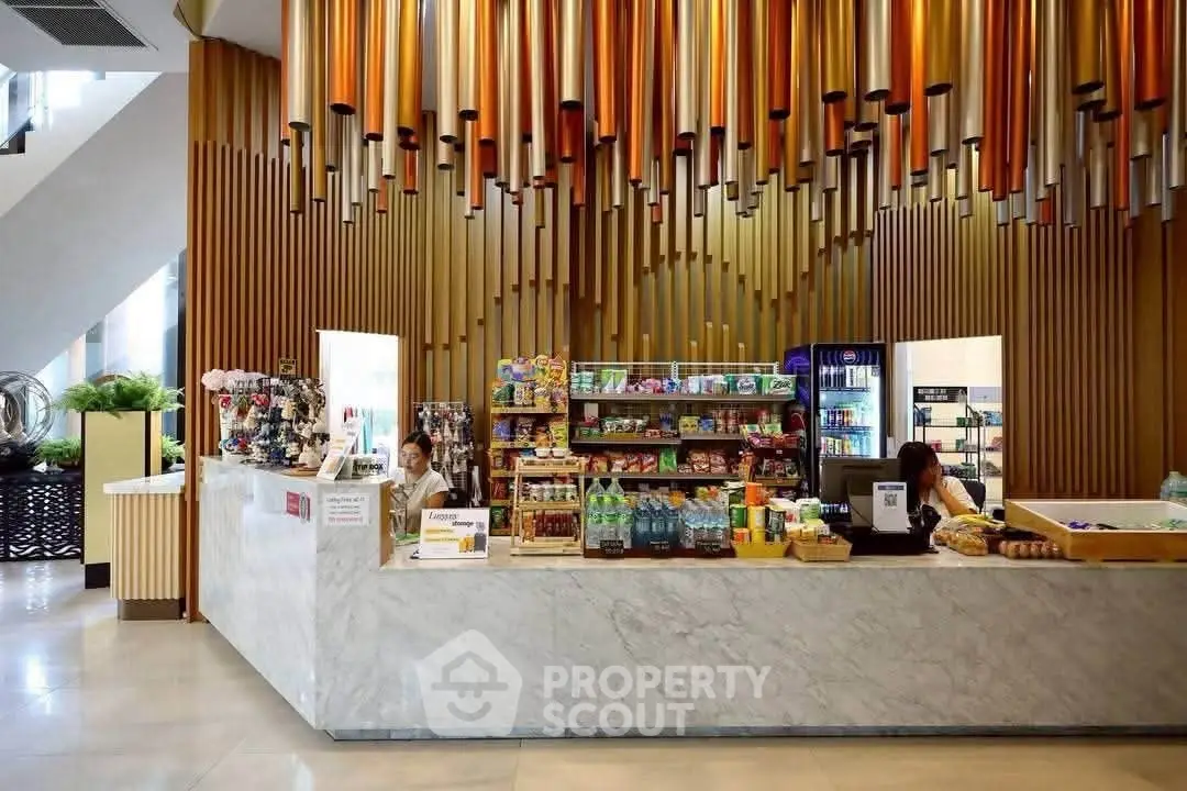 Modern lobby with stylish snack bar and unique ceiling design in upscale building.