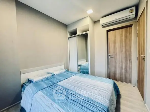 Cozy bedroom with modern decor and air conditioning unit.