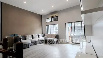 Spacious living room with modern decor and large windows for natural light.