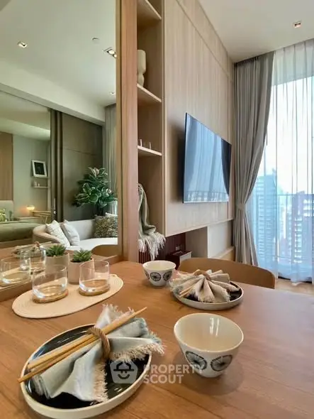 Modern living room with elegant decor and city view, featuring a stylish dining setup and large TV.