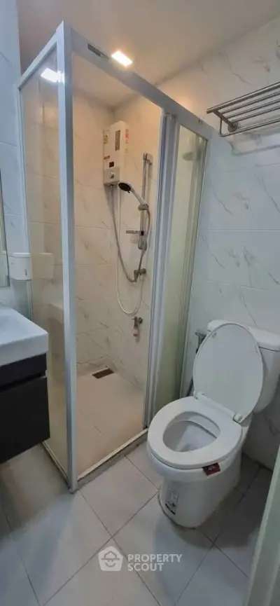 Modern bathroom with glass shower enclosure and sleek fixtures