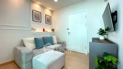 Modern living room with cozy sofa and wall-mounted TV in stylish apartment.
