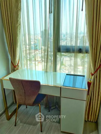 Bright study area with city view, featuring elegant desk and chair by large window with curtains.