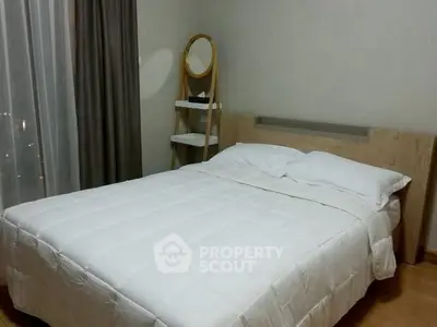 Cozy bedroom with modern decor and comfortable bedding in a stylish apartment.