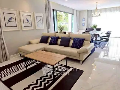 Spacious modern living room with elegant decor and open dining area, perfect for entertaining.