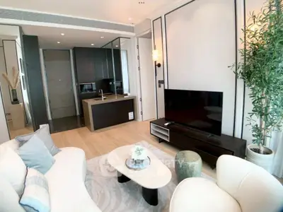 Modern living room with sleek design, open kitchen, and stylish decor in a luxurious apartment.