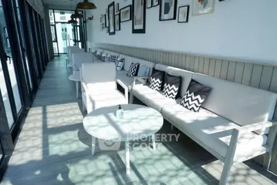 Stylish modern lounge area with chic decor and ample natural light, perfect for relaxation or social gatherings.