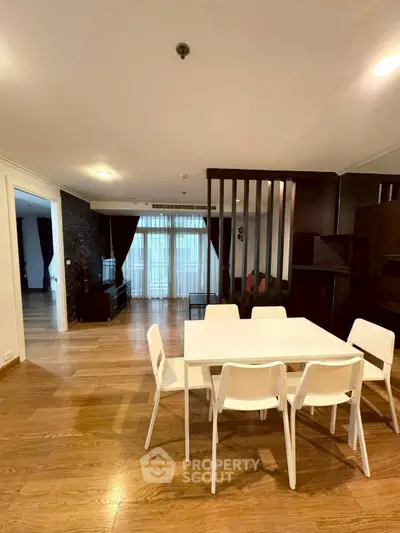 Spacious modern living room with dining area and wooden flooring