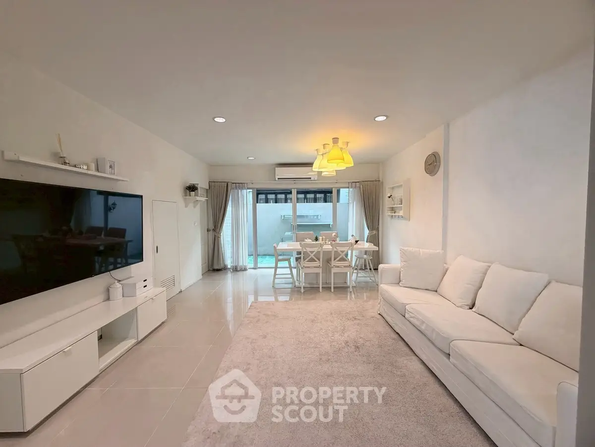 Spacious modern living room with elegant decor and large windows for natural light.