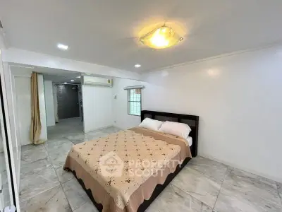 Spacious bedroom with modern decor and marble flooring