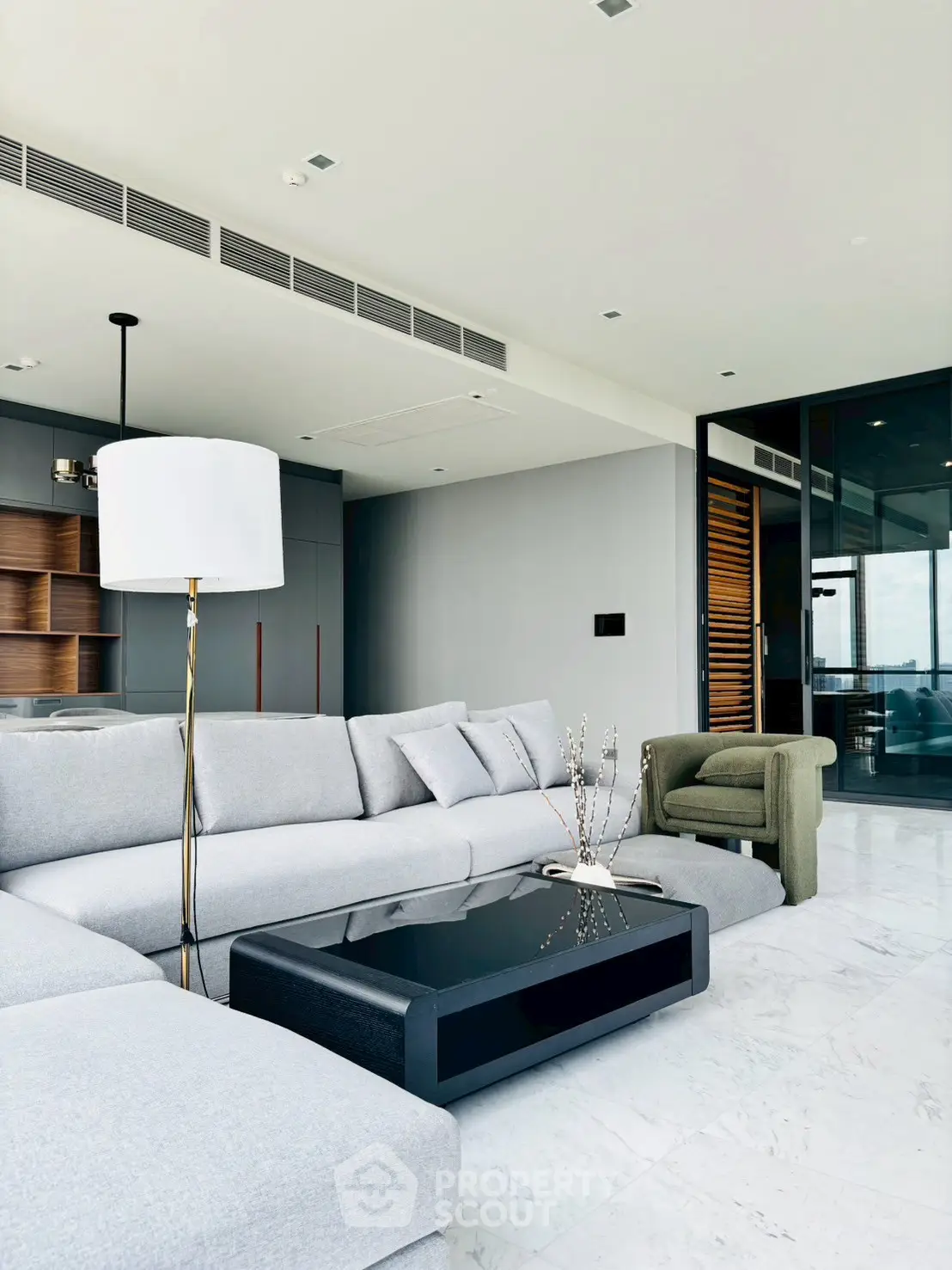 Luxurious modern living room with sleek furniture and panoramic windows.