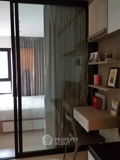 Modern compact bedroom with sliding glass door and cozy study nook