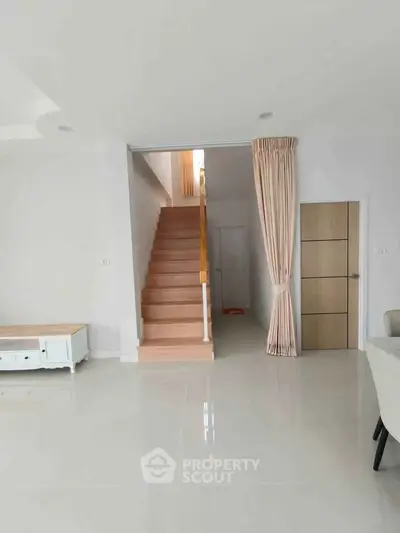 Modern interior with staircase and elegant decor in a spacious living area.