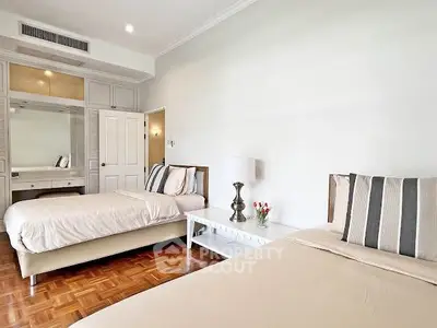 Spacious bedroom with twin beds and elegant decor in modern apartment