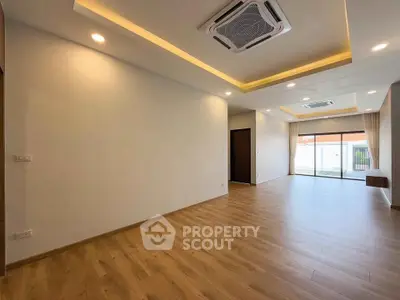 Spacious modern living room with wooden flooring and recessed lighting