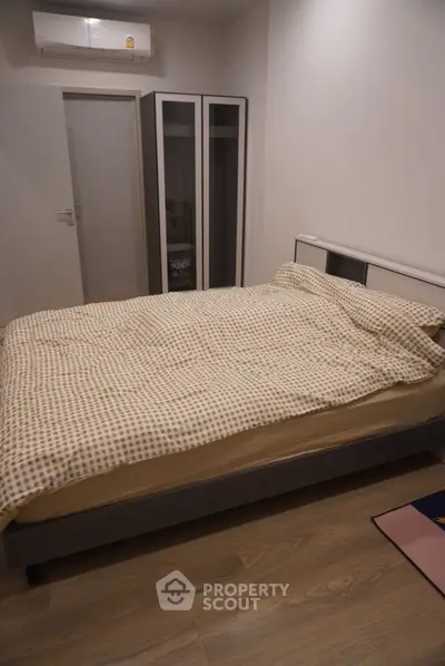 Cozy bedroom with modern design and ample storage space.