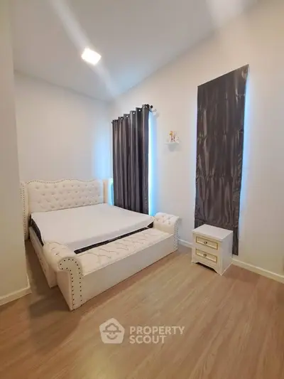 Elegant bedroom with luxurious bed and stylish curtains in modern apartment