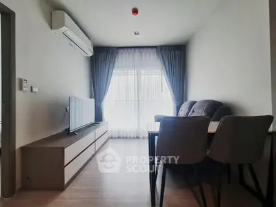 Modern living room with sleek furniture and natural light, perfect for cozy gatherings.