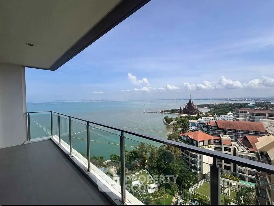 Stunning balcony view overlooking the ocean and cityscape, perfect for relaxation and enjoying sunsets.