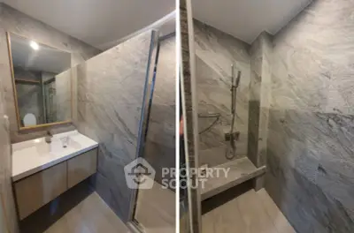 Modern bathroom with sleek stone tiles and spacious shower area