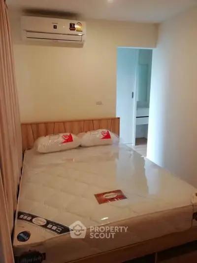 Cozy bedroom with air conditioning and modern furnishings, perfect for comfortable living.