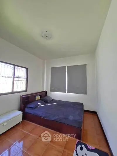 Spacious bedroom with natural light and modern furnishings