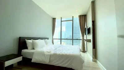 Luxurious bedroom with floor-to-ceiling windows offering stunning city views in a modern high-rise apartment.