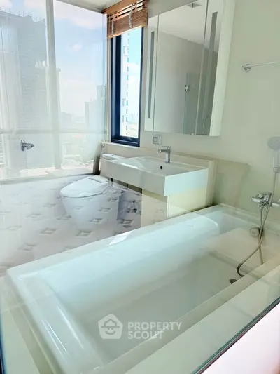 Luxurious bathroom with modern fixtures and stunning city view from high-rise apartment.