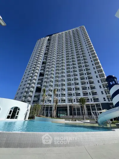 Stunning high-rise building with pool and modern architecture under clear blue sky.