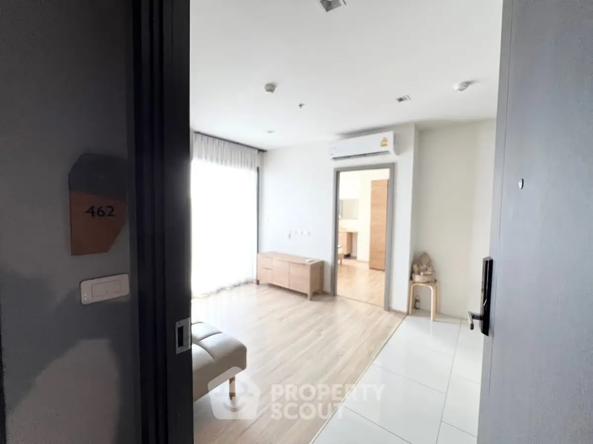 Modern apartment entrance with sleek interior design and natural light