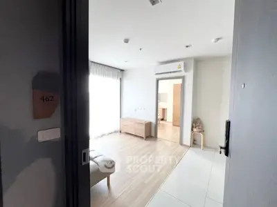 Modern apartment entrance with sleek interior design and natural light