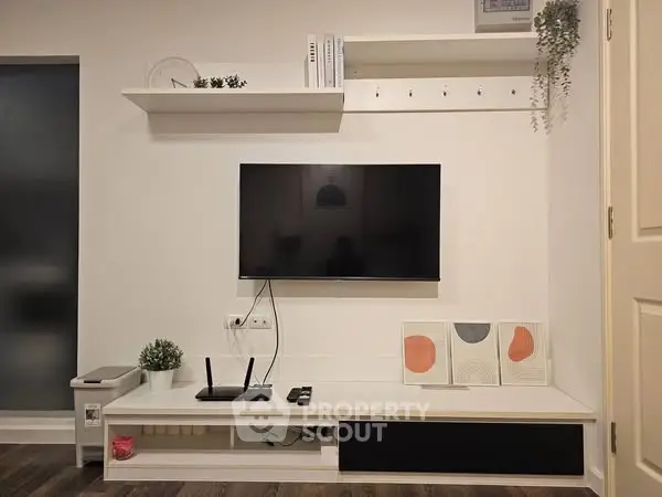 Modern living room with wall-mounted TV and minimalist decor