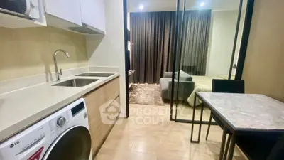 Modern studio apartment with compact kitchen and cozy bedroom area