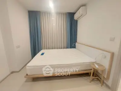 Modern minimalist bedroom with large window and air conditioning unit