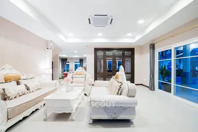 Luxurious living room with elegant sofas and large windows offering a serene view.