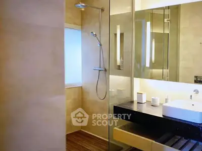 Modern bathroom with sleek shower and elegant vanity in luxury home.