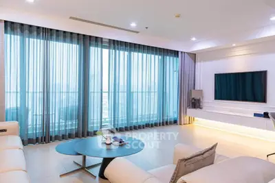 Spacious modern living room with large windows and elegant decor