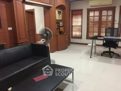 Spacious living room with modern furniture and wooden accents, perfect for relaxation and work-from-home setup.