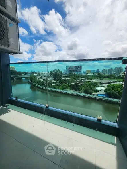 Stunning balcony view overlooking a serene river and cityscape, perfect for relaxation.