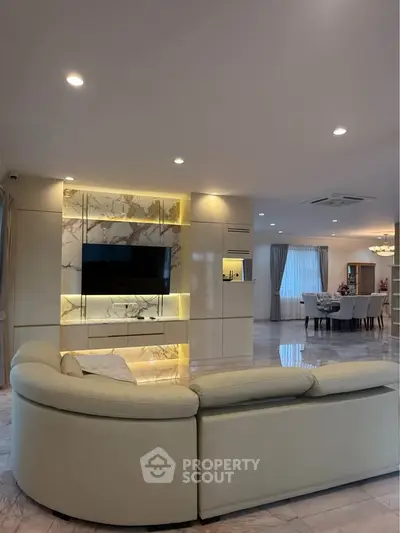 Luxurious living room with elegant marble accents and modern lighting