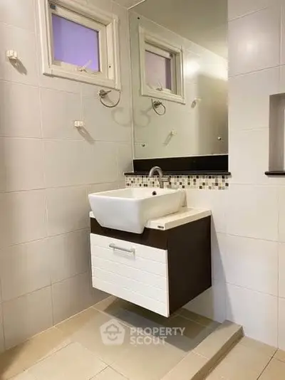 Modern bathroom with sleek sink and stylish tile design