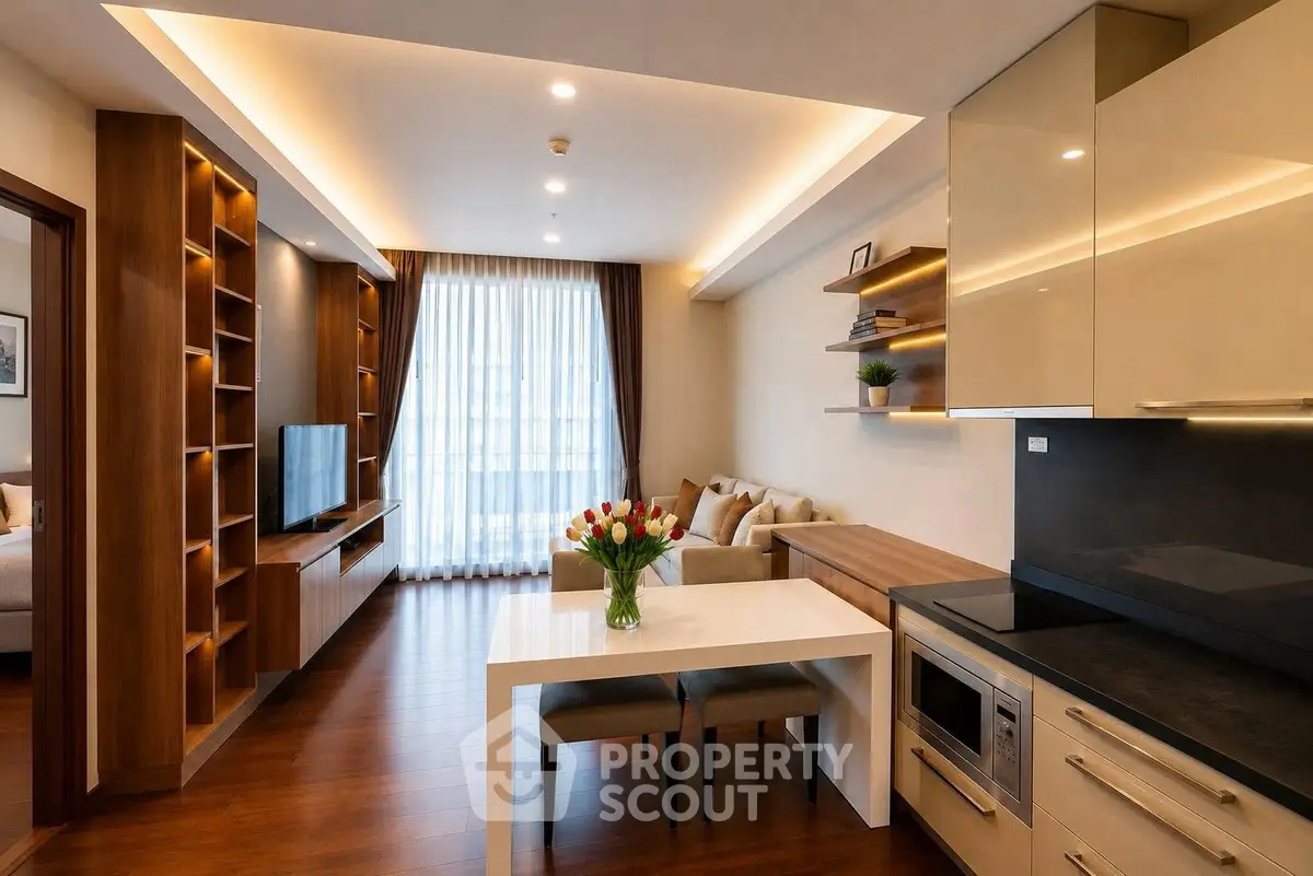 Modern open-plan living room and kitchen with elegant decor and natural light.