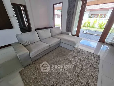Spacious living room with cozy sectional sofa and garden view