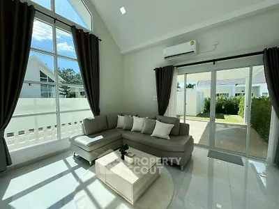 Spacious living room with high ceilings and large windows in modern home