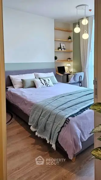 Cozy bedroom with modern decor and study nook, perfect for relaxation and productivity.