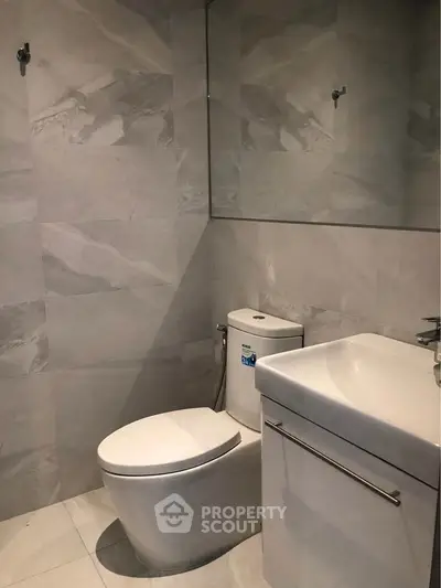 Modern bathroom with sleek fixtures and elegant tile design.