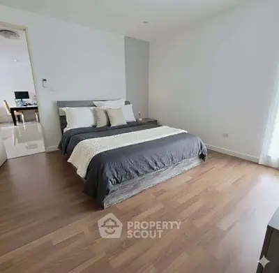 Modern bedroom with wooden flooring and stylish decor